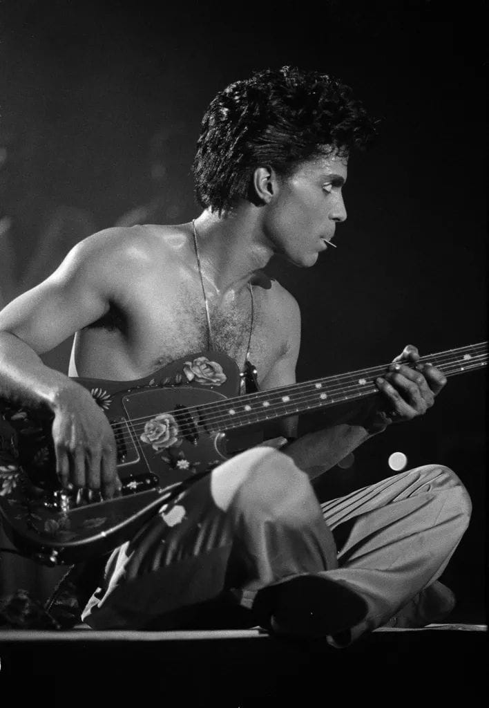 Prince playing the guitar in 1986